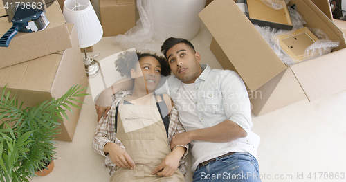 Image of Dreaming young couple lying on the floor