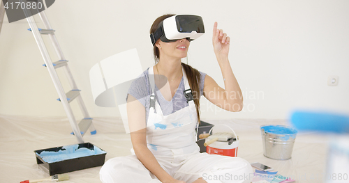 Image of Young woman using virtual reality goggles