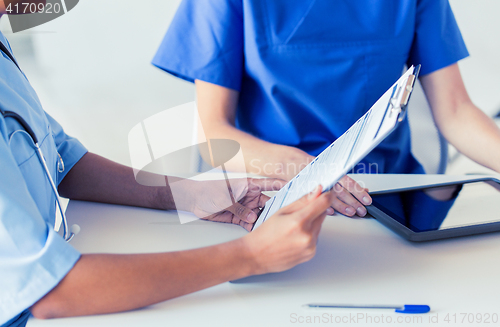 Image of close up of doctor with medical report at hospital