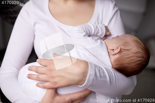 Image of close up of mother holding newborn baby