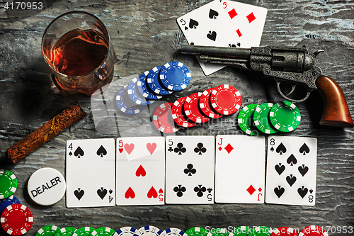 Image of Cigar, chips for gamblings, drink and playing cards