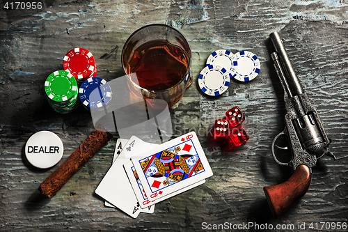 Image of Cigar, chips for gamblings, drink and playing cards