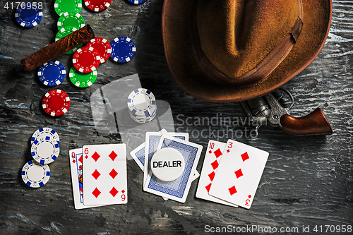 Image of Cigar, chips for gamblings, drink and playing cards