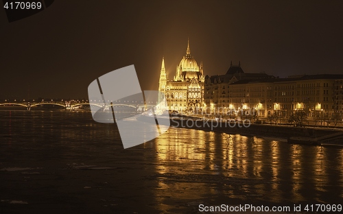 Image of Parliament at nighttime with icy Danube