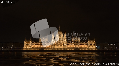 Image of Parliament at nighttime with icy Danube