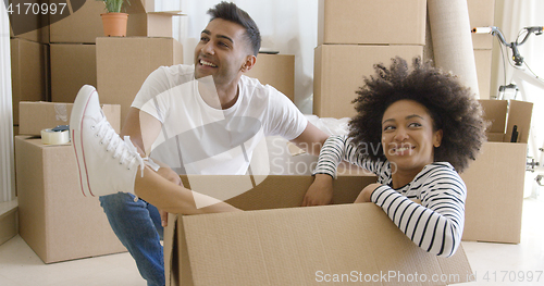 Image of Smiling young woman in a cardboard carton