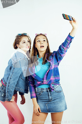 Image of lifestyle people concept: two pretty stylish modern hipster teen girl having fun together, happy smiling making selfie 