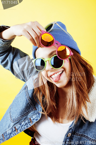 Image of young pretty teenage hipster girl posing emotional happy smiling on white background, lifestyle people concept close up