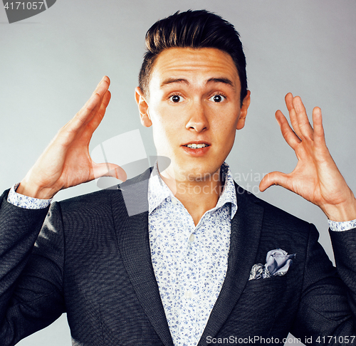 Image of young pretty business man standing on white background, modern hairstyle, posing emotional, lifestyle people concept 