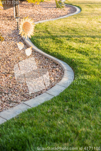 Image of Beautiful Concrete Coping Along Lush Green Grass in Yard.