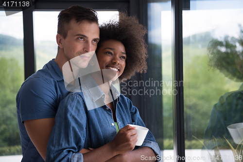 Image of romantic happy young couple relax at modern home indoors