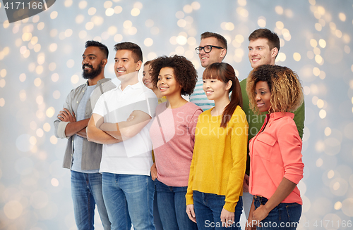 Image of international group of happy people over lights