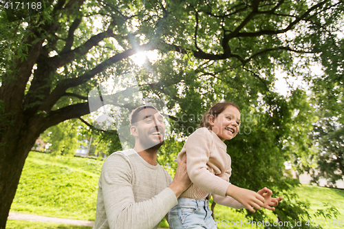 Image of happy family having fun in summer park