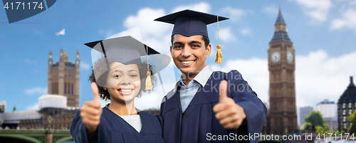 Image of happy students or bachelors showing thumbs up
