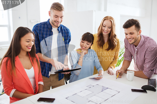 Image of creative team with blueprint working at office