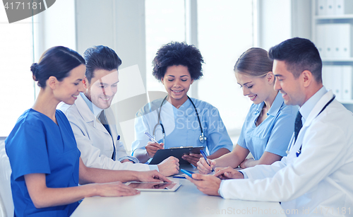 Image of group of happy doctors meeting at hospital office