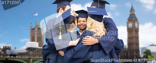 Image of happy students or bachelors hugging