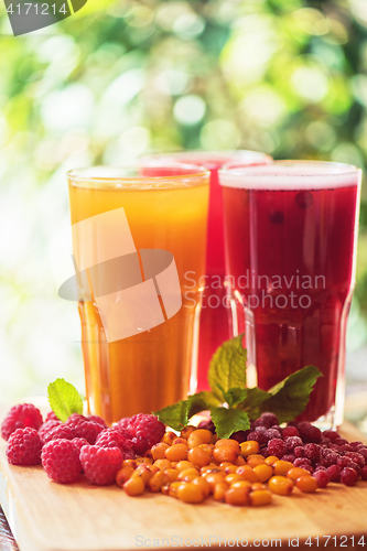 Image of fruit drink with cranberries raspberries and sea buckthorn