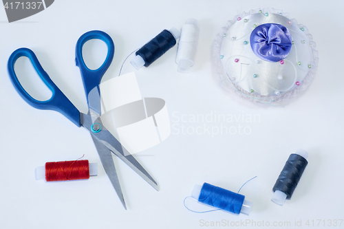 Image of Tailoring tools are scissors needle and threads