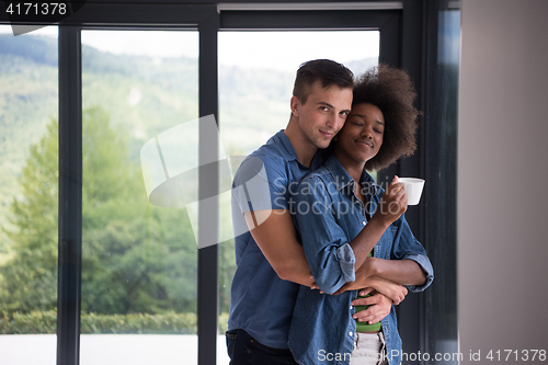 Image of romantic happy young couple relax at modern home indoors