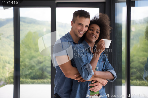 Image of romantic happy young couple relax at modern home indoors