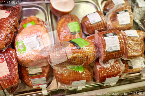 Image of ham at grocery store stall