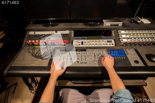 Image of man using mixing console in music recording studio