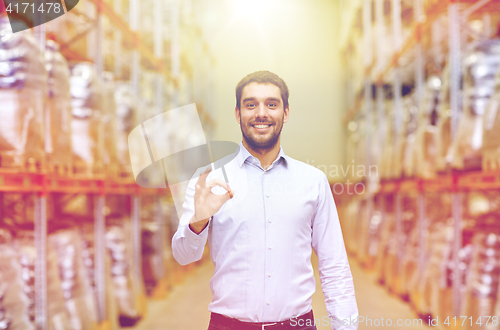 Image of happy man at warehouse showing ok gesture