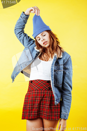 Image of lifestyle people concept: two pretty school girl having fun on yellow background, happy smiling students