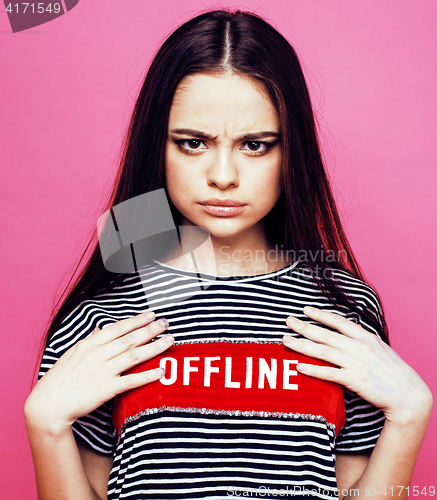 Image of young pretty teenage woman emotional posing on pink background, fashion lifestyle people concept 