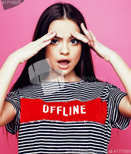 Image of young pretty teenage woman emotional posing on pink background, fashion lifestyle people concept 