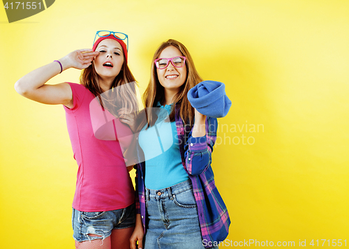 Image of lifestyle people concept: two pretty stylish modern hipster teen girl having fun together, happy smiling making selfie