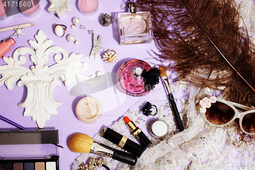 Image of Jewelry table with lot of girl stuff on it, little mess in cosmetic brushes, women interior concept, perfume elegance things, little princess makeup