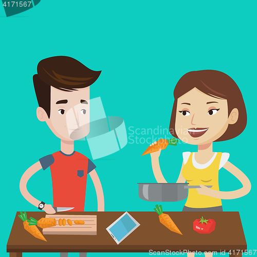 Image of Couple cooking healthy vegetable meal.