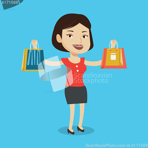 Image of Happy woman holding shopping bags.