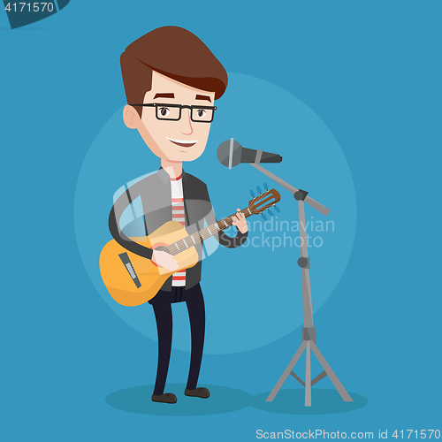 Image of Man singing in microphone and playing guitar.