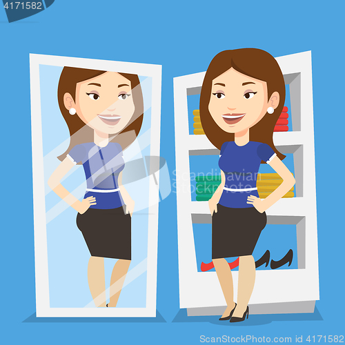 Image of Woman trying on clothes in dressing room.