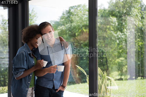 Image of romantic happy young couple relax at modern home indoors