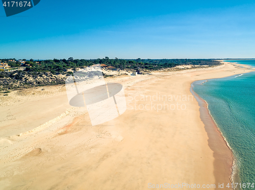 Image of Aerial View Empty Sandy Beach with Small Waves