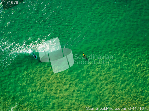 Image of Surfers Waiting Waves on the Surface of the Ocean