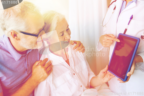 Image of senior woman and doctor with tablet pc at hospital