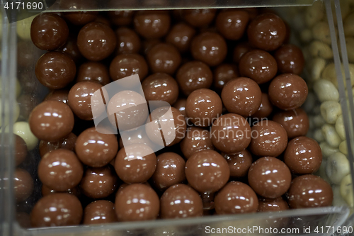 Image of close up of chocolate dragee candies in box