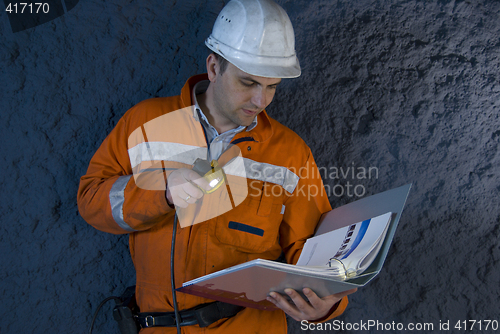 Image of Engineer checking the plan