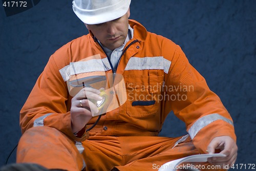 Image of Engineer checking the plans