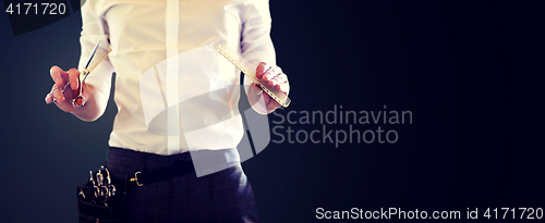 Image of close up of male stylist with scissors at salon