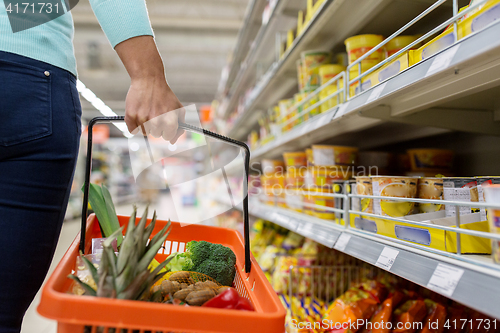 Image of woman with food basket at grocery or supermarket