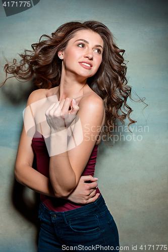 Image of Pretty girl with long hair smiling and enjoying life
