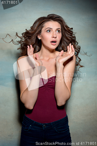 Image of Portrait of young woman with shocked facial expression