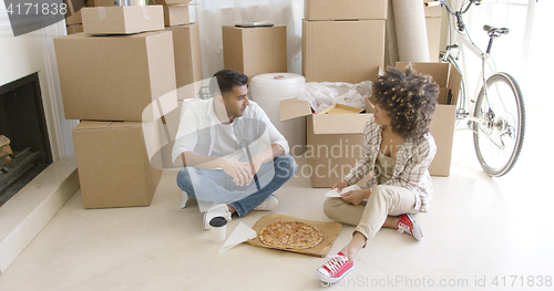 Image of Young couple taking a break from moving house