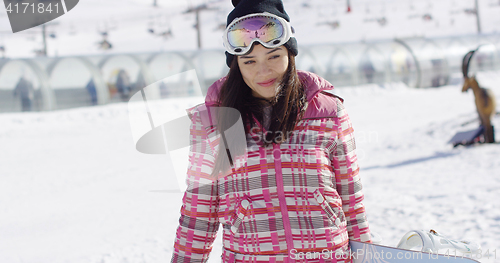 Image of Cute and happy female asian snowboarder